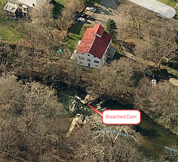 Aerial view showing mill and breached dam